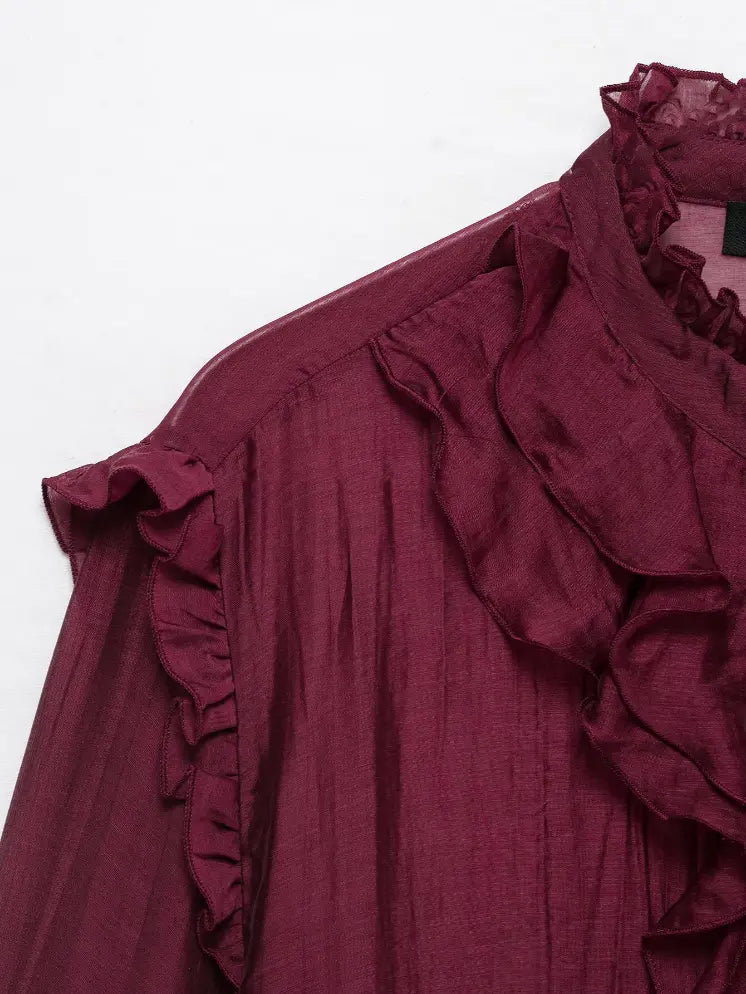 Close-up of shoulder ruffle and stand collar