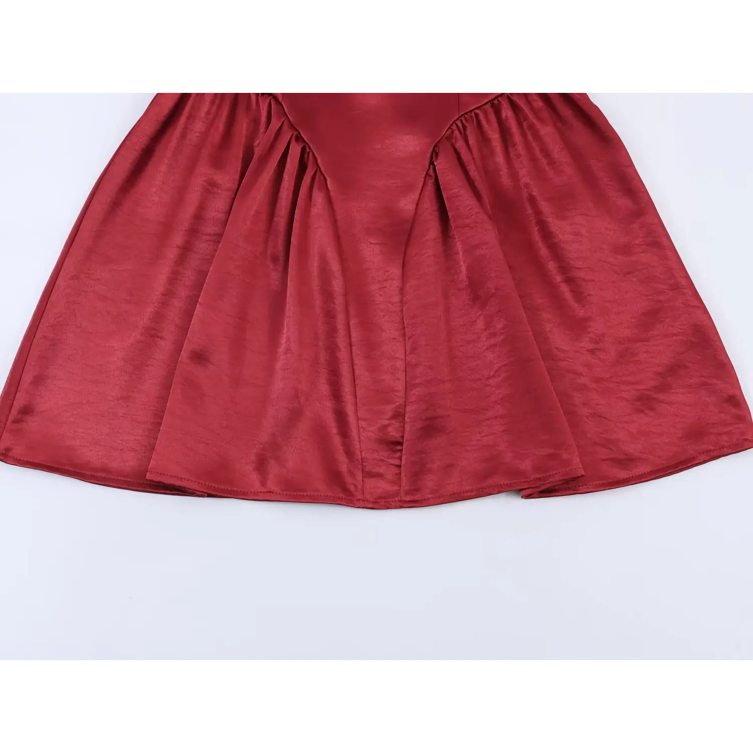 Lower skirt full panel shot, heavy evenly distributed gathering at waist seam, multi-panel flared A-line mini hem, soft drape of crinkled satin