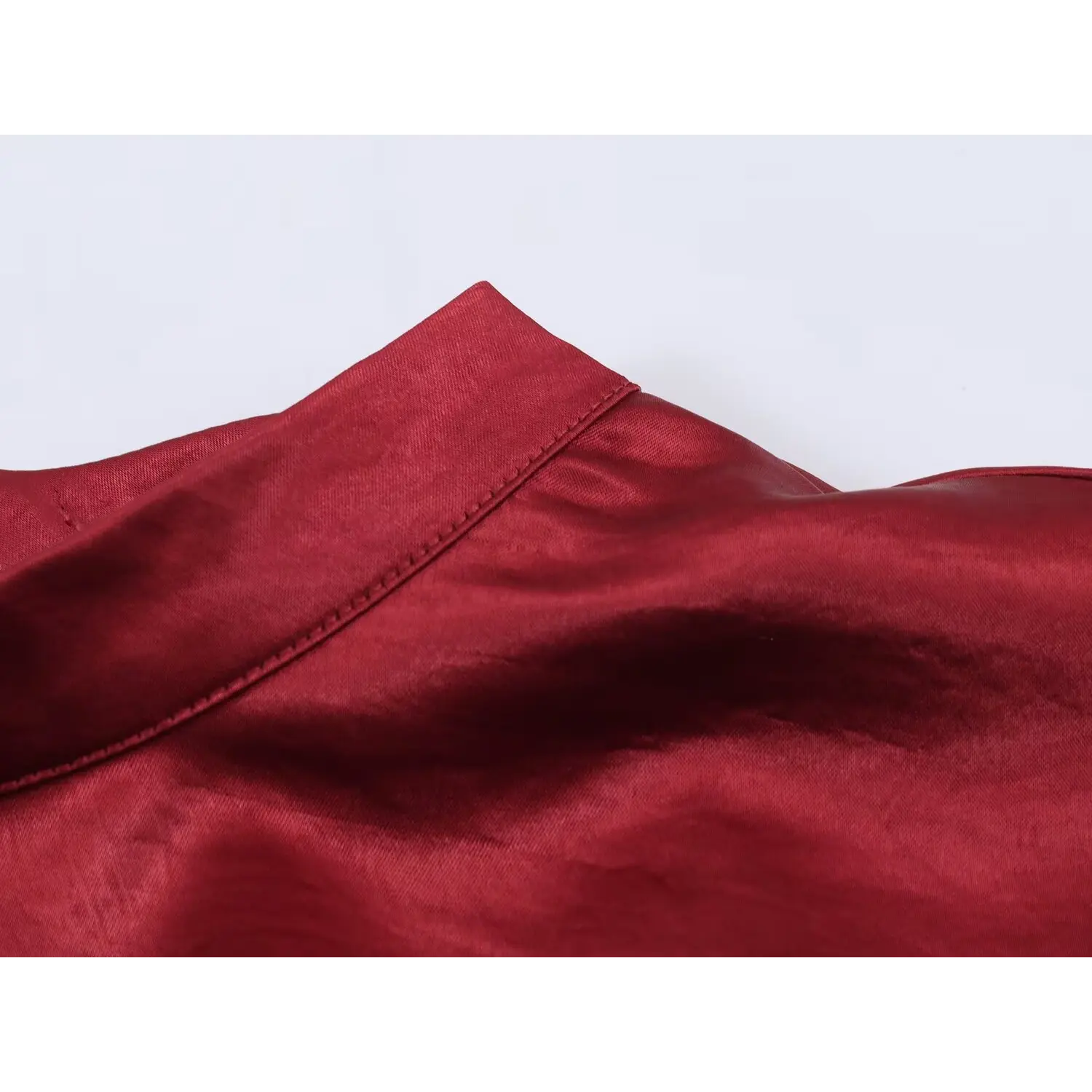 Mock neck edge close-up, double parallel topstitch folded binding, smooth folded collar band, uniform fabric grain direction