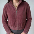 Model wearing burgundy stand collar zip up cropped suede bomber jacket front view