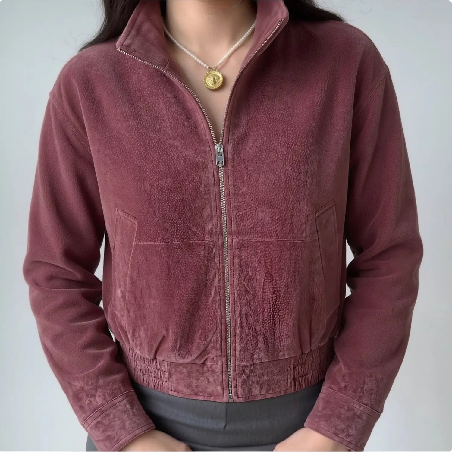 Model wearing burgundy stand collar zip up cropped suede bomber jacket front view