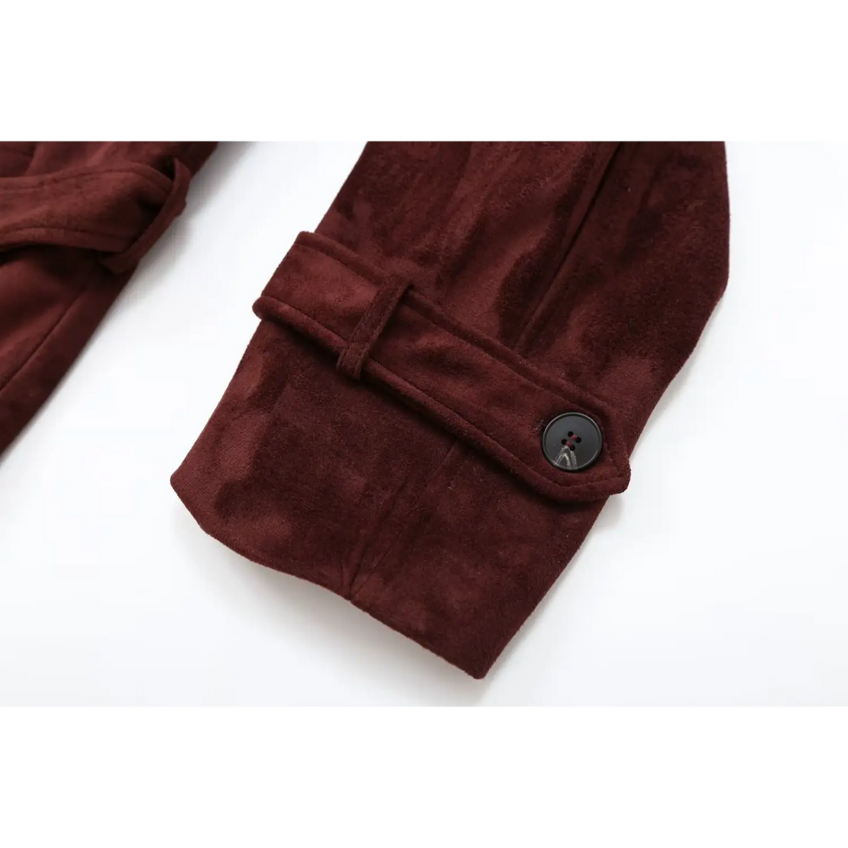 Close-up of adjustable cuff strap and black button