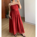 Straight front indoor mirror lifestyle photo of rich red vertical textured tier maxi slip dress, fitted empire waist, flowy layered floor skirt, paired with thin black heeled slide sandals
