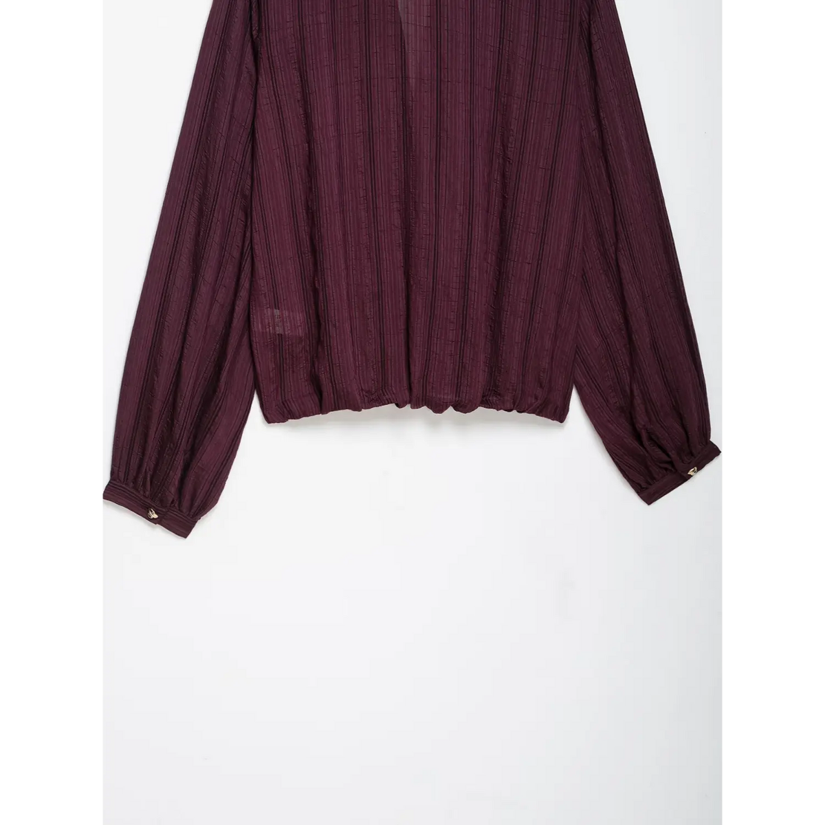 Back flat lay showing cuffs and elastic hem