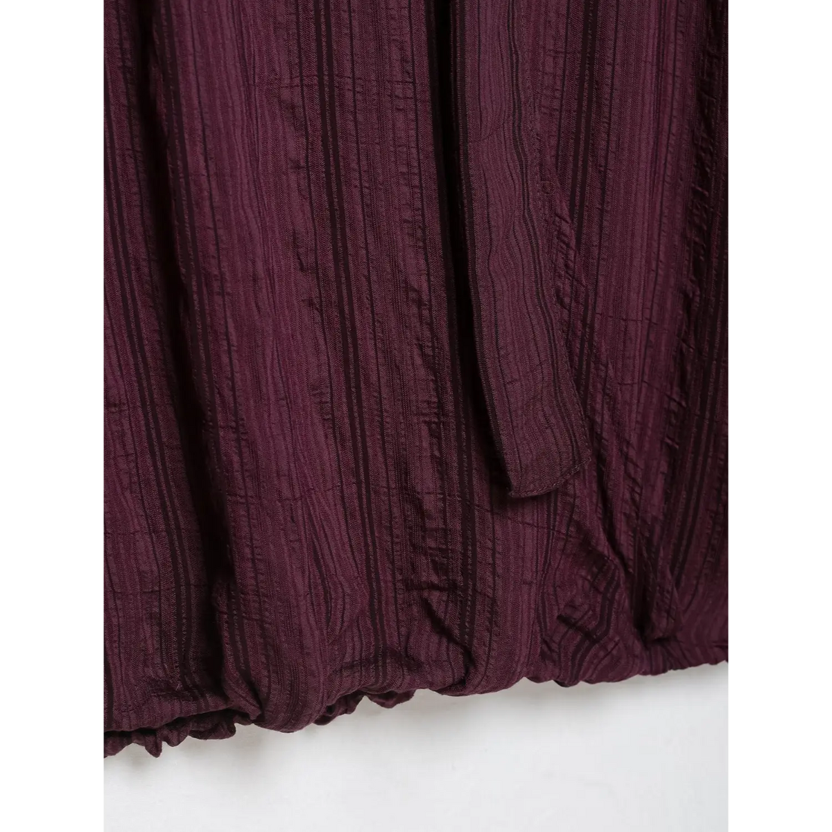 Close-up of elastic hem and tie strap