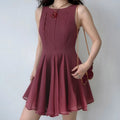 Model daily shot matte wine red textured sleeveless mini dress, simple round neck, vertical tailored waist darts, full bouncy A-line skirt, styled with vintage red pendant chain & butterfly shoulder bag, soft romantic date outfit