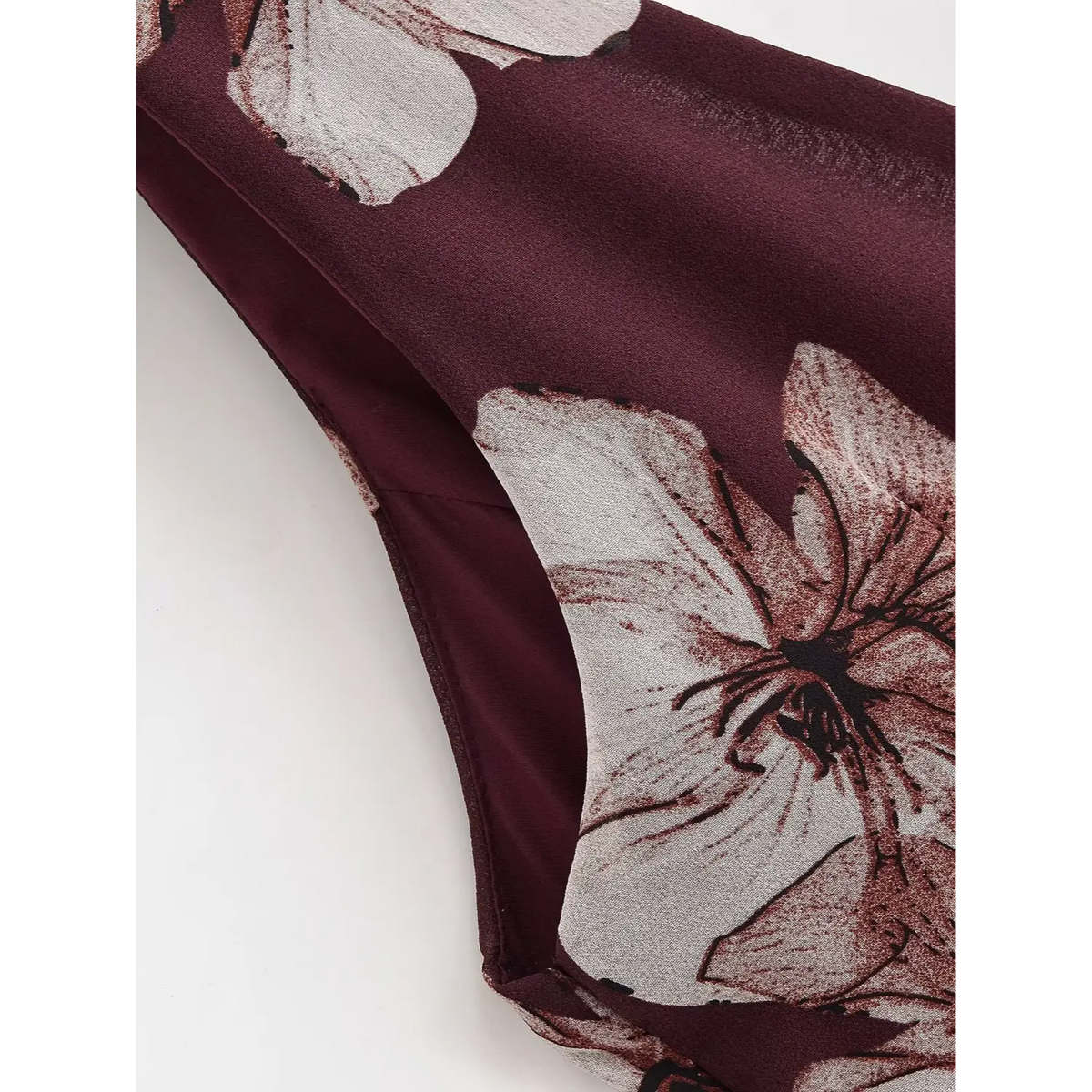 Partial shot of armhole edge with floral chiffon print