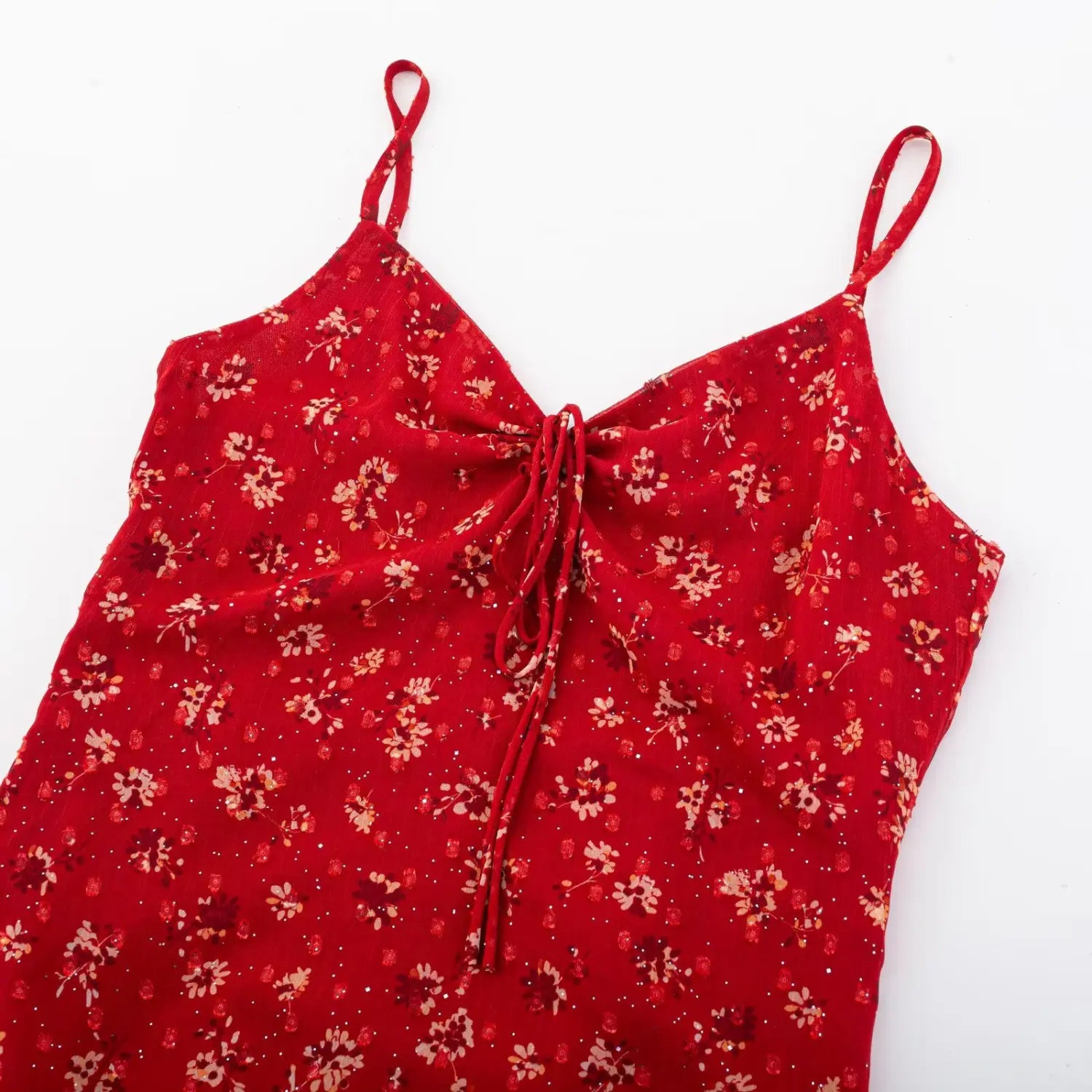 Dress V-neck drawstring macro close-up, matching print fabric tie adjustable neck depth ruffle shaping bust fabric detail shot