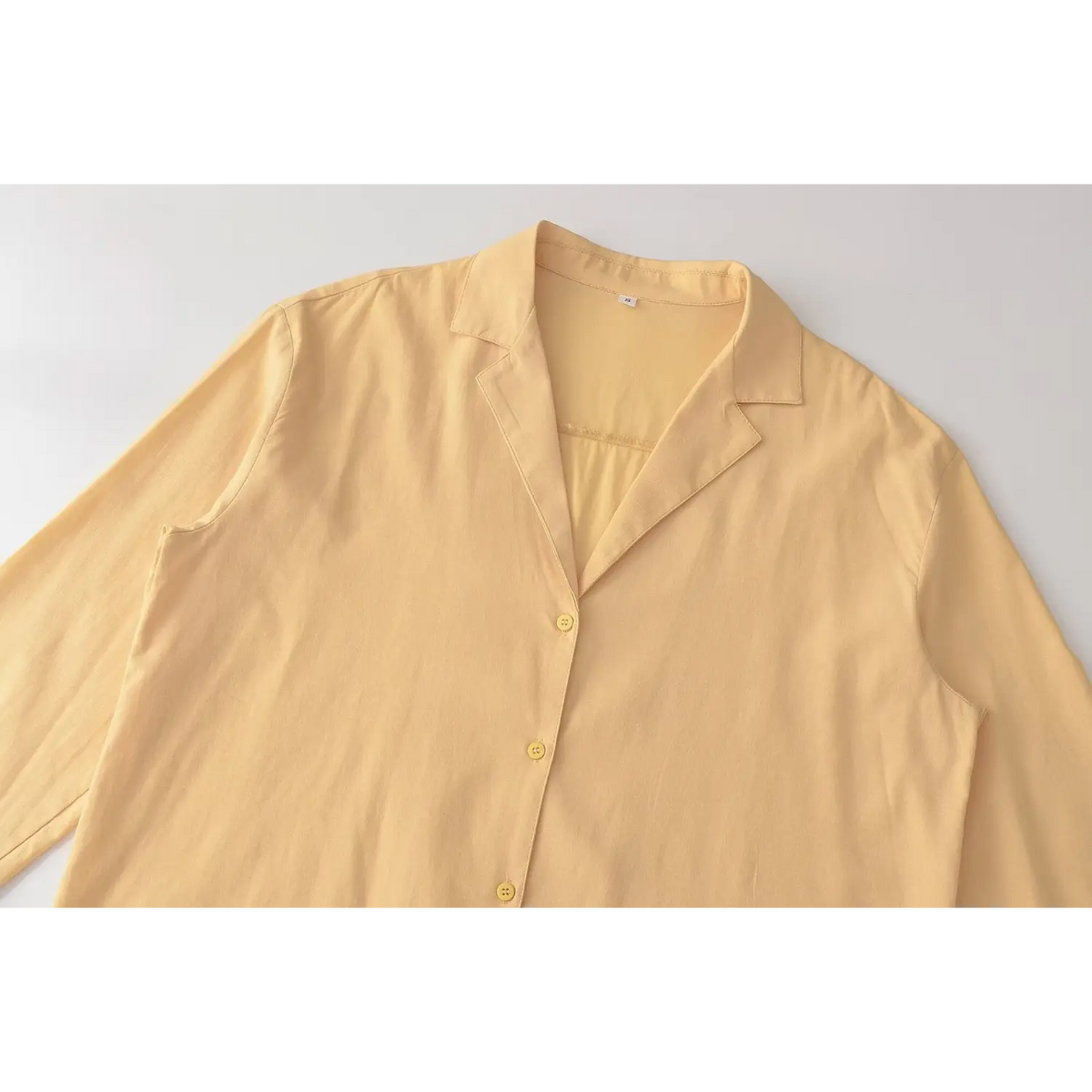Close-up of blazer collar and button placket