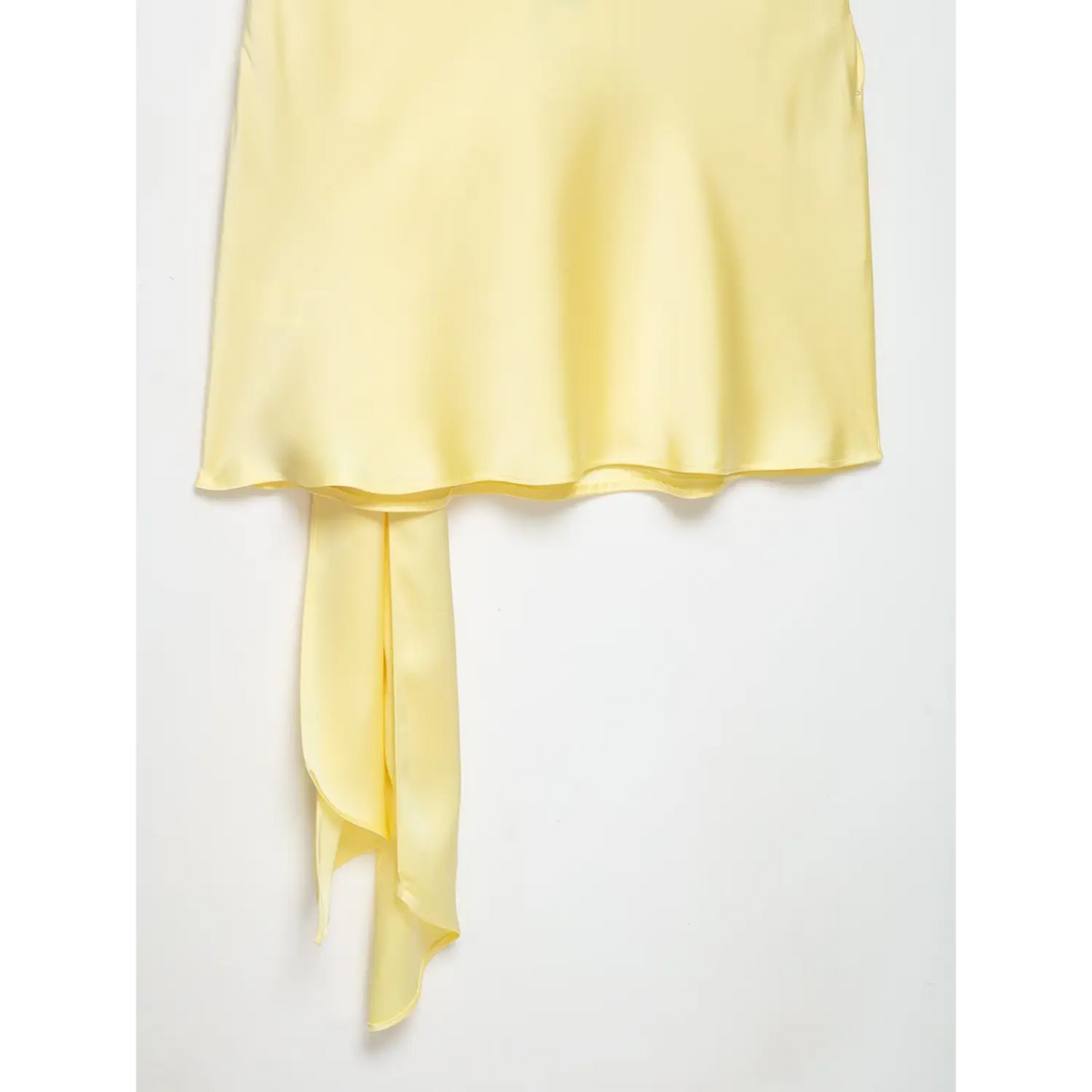 Close-up of skirt hem and tie sash