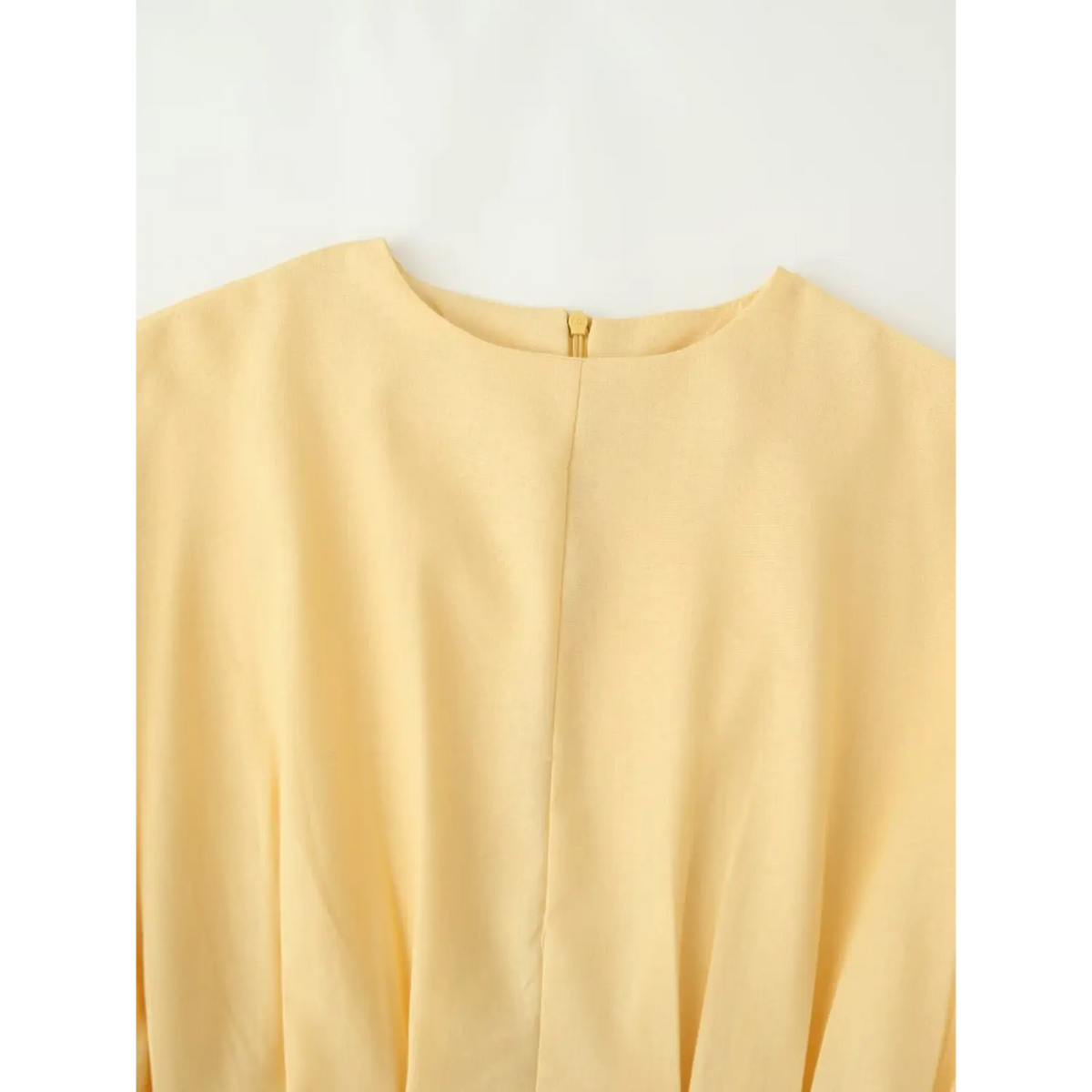 Close-up of round neckline and back zip