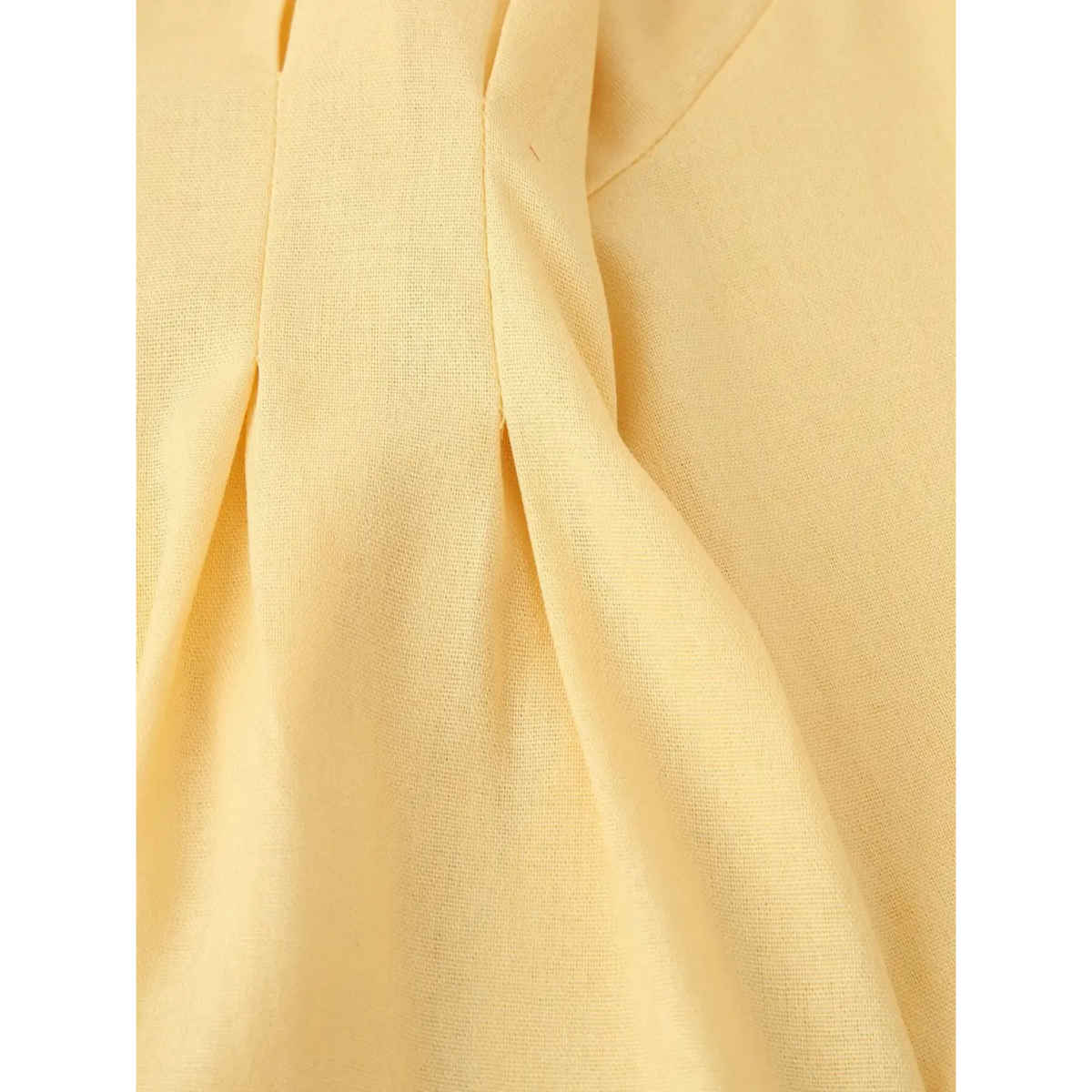 Close-up of waist pleats and stitching