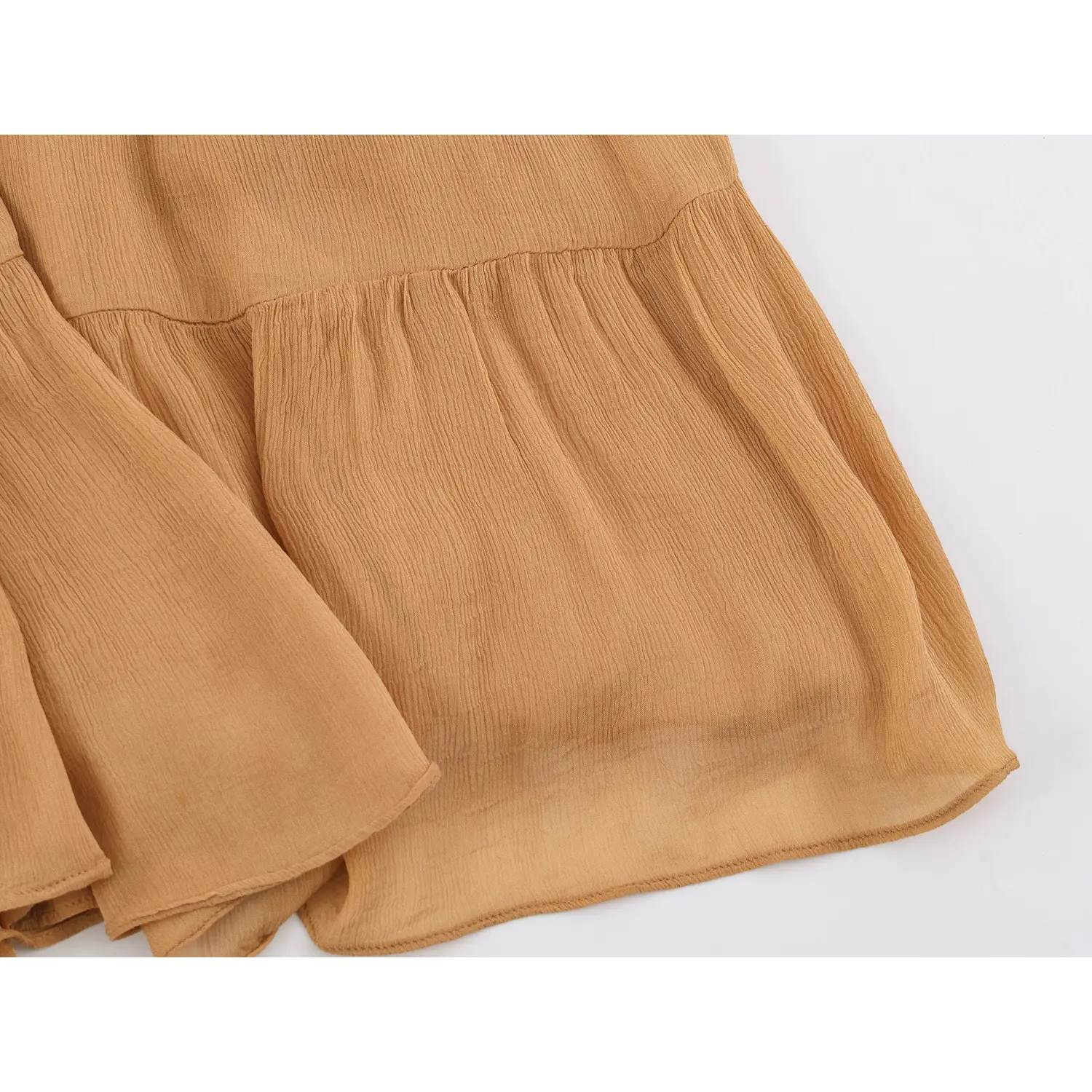 Close‑up of ruffle seam and crinkled chiffon skirt hem