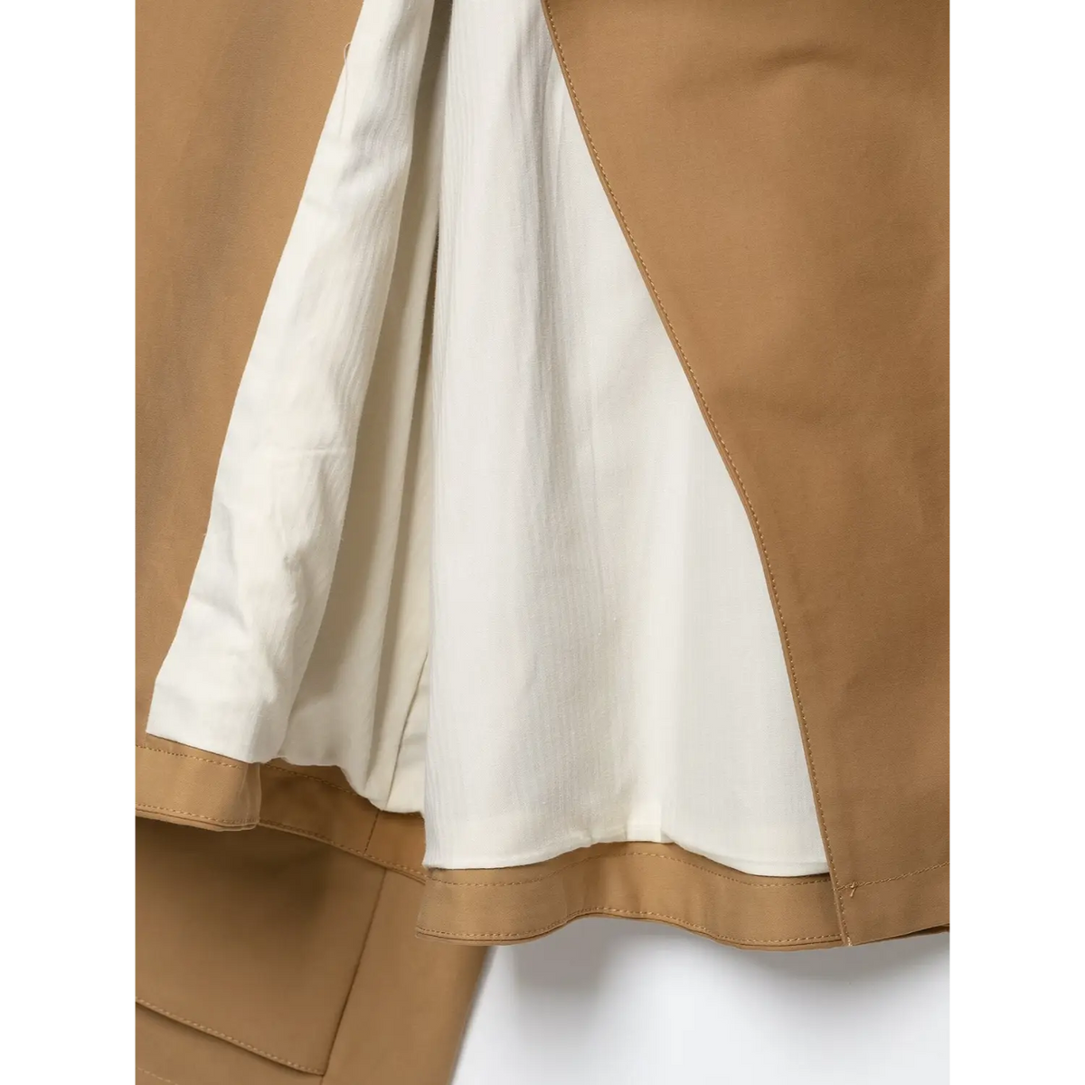 Inside close-up of camel cropped jacket, showcasing soft white inner lining and hem stitching