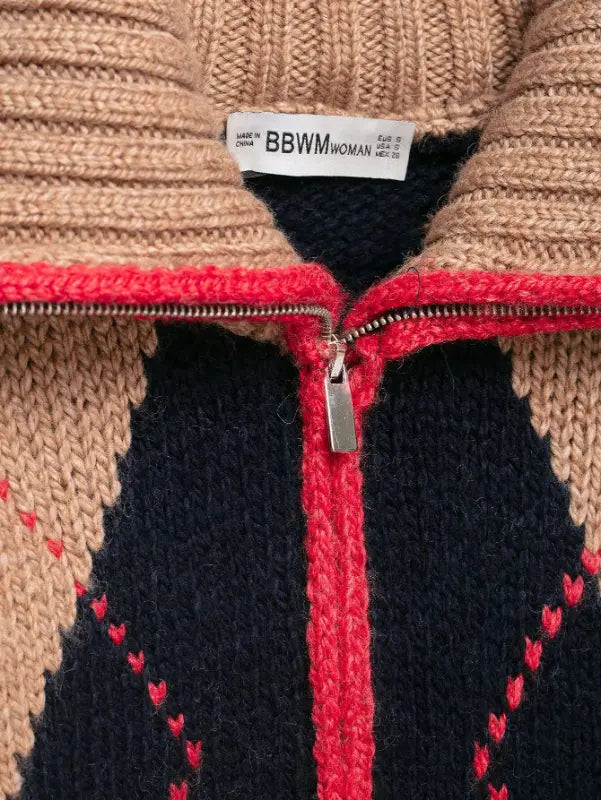 Macro close-up of silver zipper pull and red trim