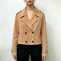 Model wearing camel suede double breasted cropped trench jacket with black trousers