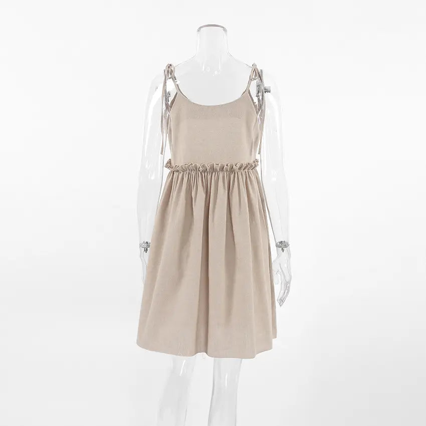 Camel tie strap babydoll ruffle waist mini dress on mannequin, back view