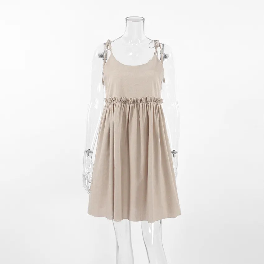 Camel tie strap babydoll ruffle waist mini dress on mannequin, front view