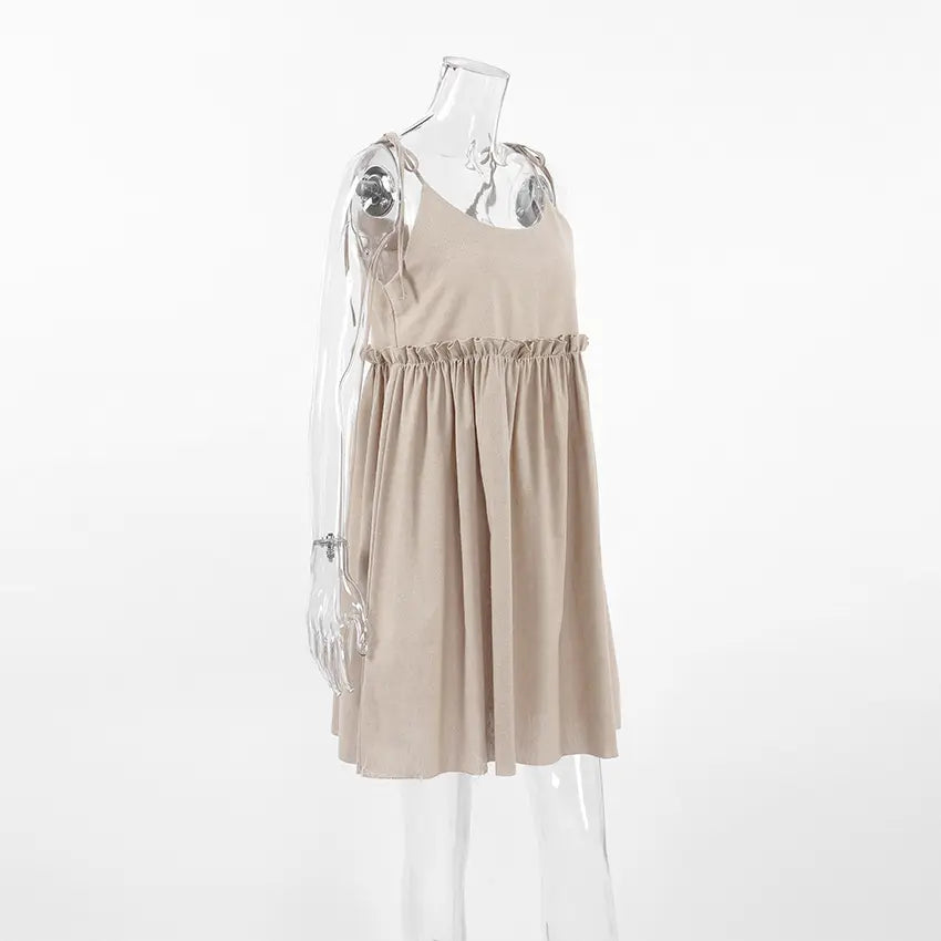 Camel tie strap babydoll ruffle waist mini dress on mannequin, three quarter view