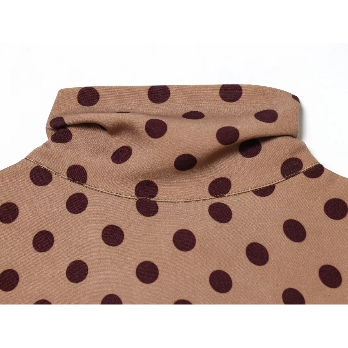 Close‑up of folded turtleneck collar with polka dot print