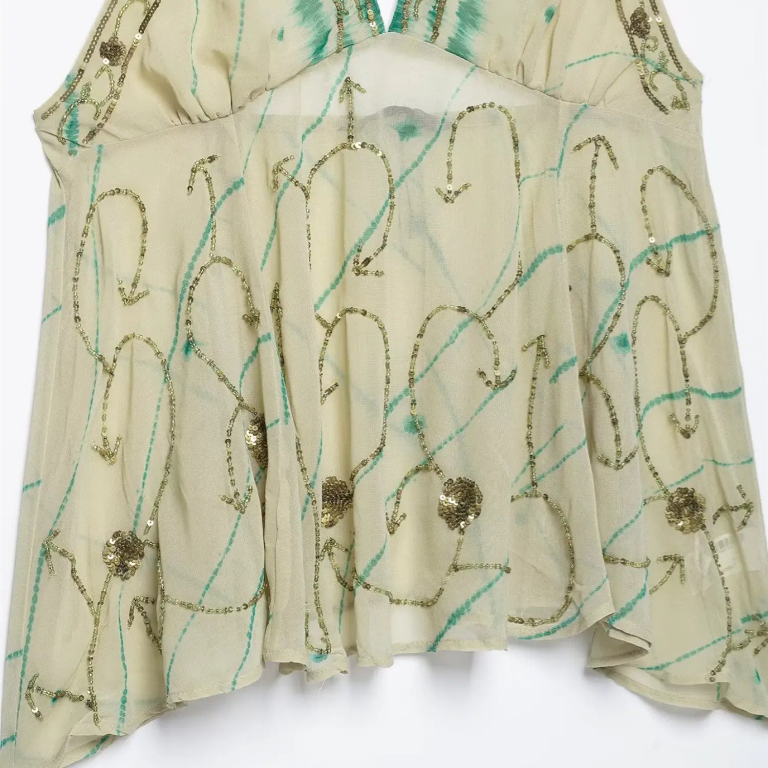 Front torso fabric close-up, curve arrow shaped golden beaded embroidery, scattered flower sequin decoration