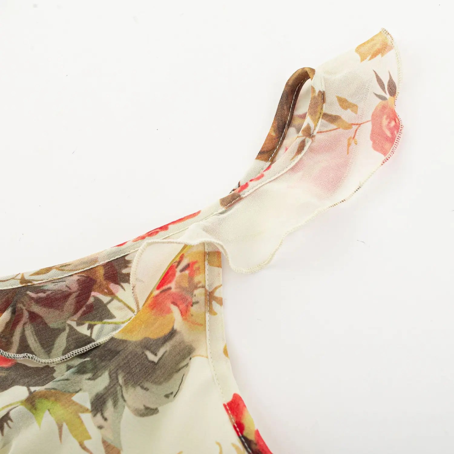 Cami strap ruffle sleeve macro close-up, chiffon frill binding soft shoulder coverage print fabric serging detail shot