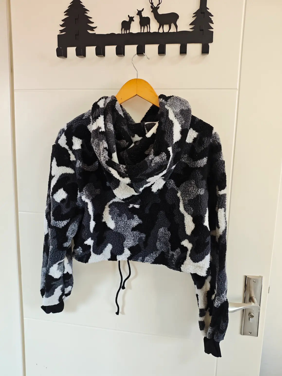 Camouflage teddy fleece hooded cropped hoodie hanging on door, back view
