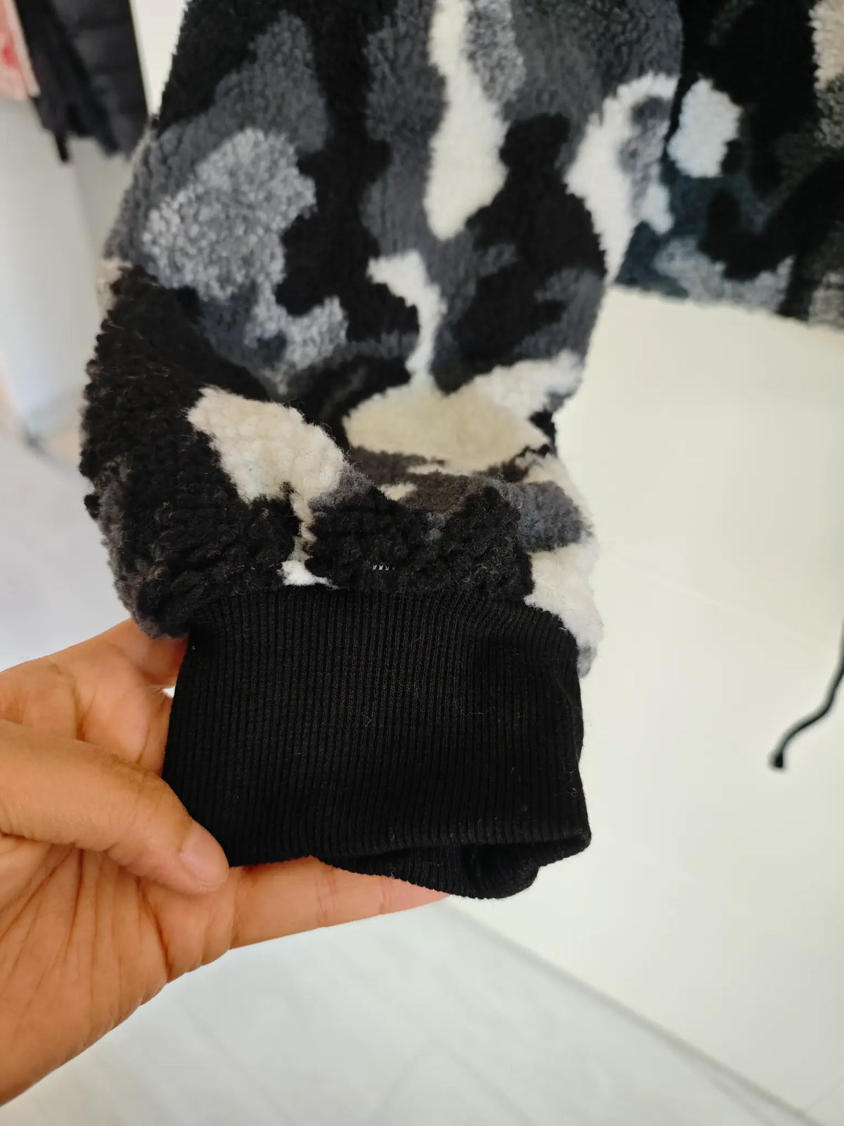 Close-up of black ribbed knit cuff