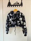 Camouflage teddy fleece hooded cropped hoodie hanging on door, front view