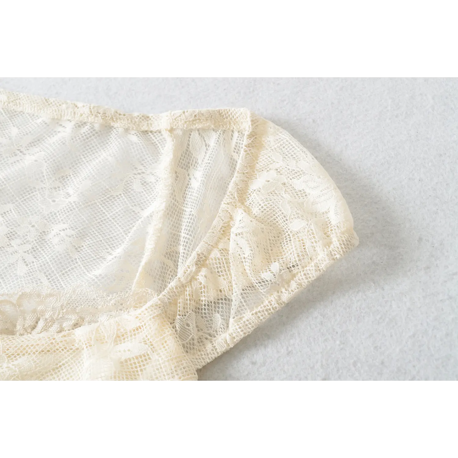 Cap puff short sleeve lace cuff macro close-up, even sleeve gathering form fluffy mini puff sleeves durable lace binding edge sheer lace sleeve layered detail shot
