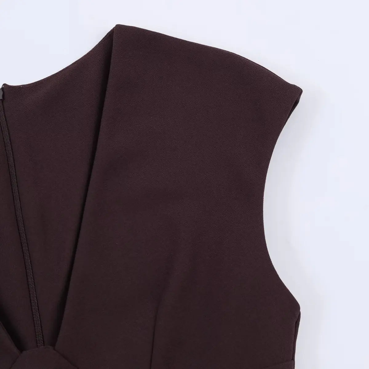 Close-up of the cap sleeve and V-neckline on a brown mini dress, showing the tailored construction and clean seams.
