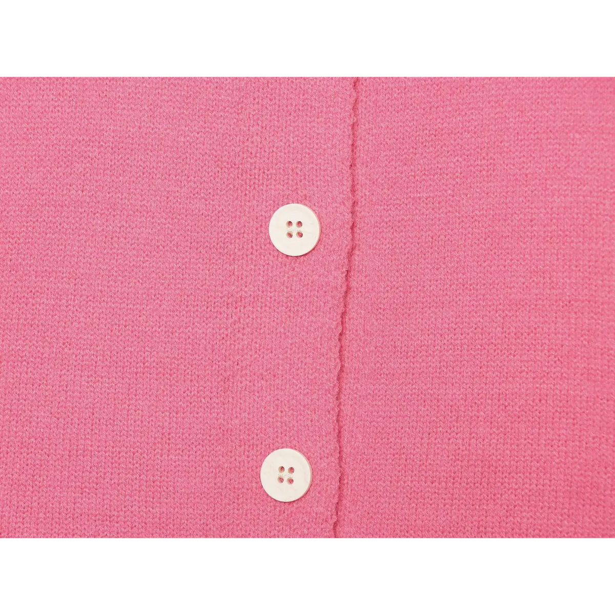 Close up of round white four-hole buttons on pink knit cardigan front placket