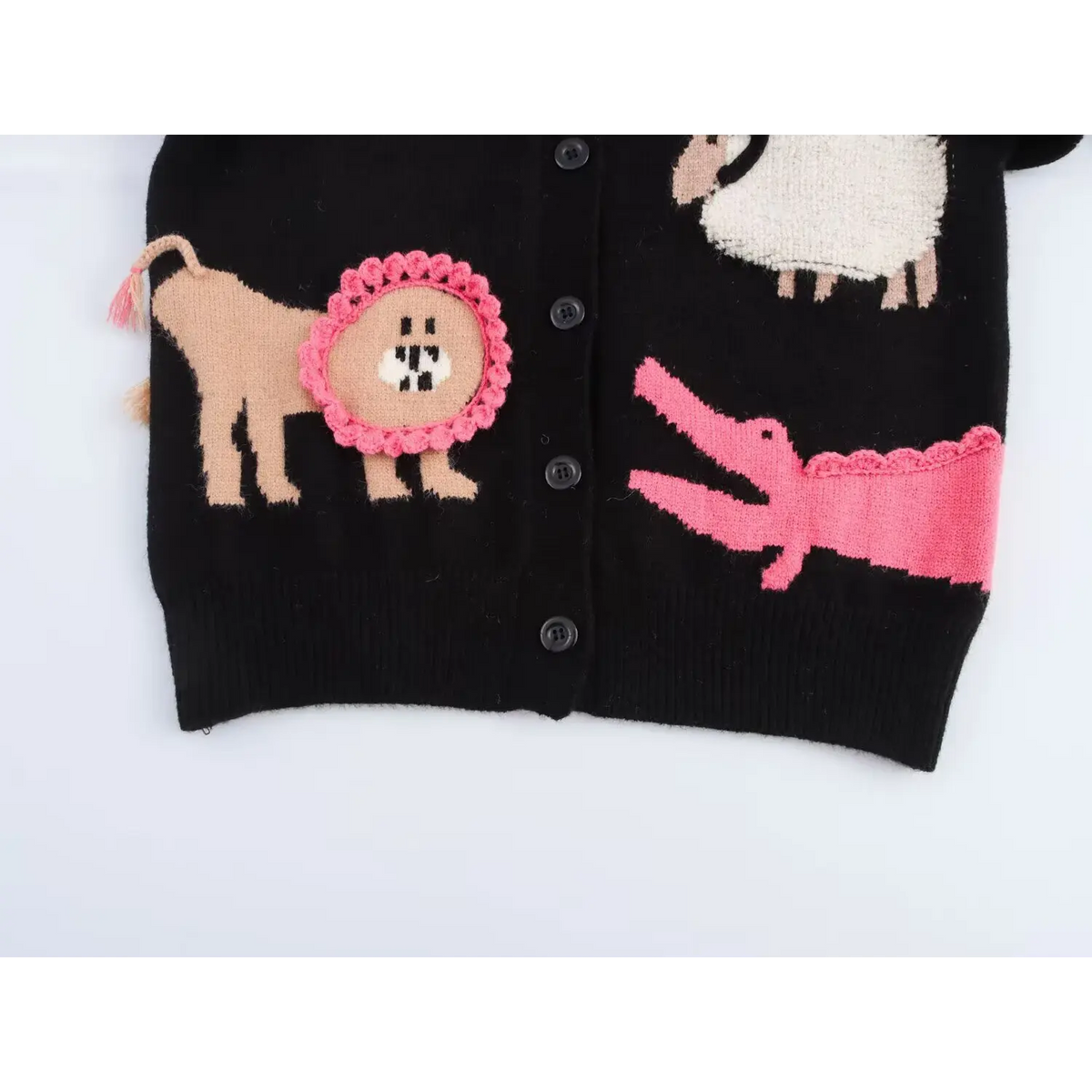 Close-up of lion sheep and crocodile intarsia motifs