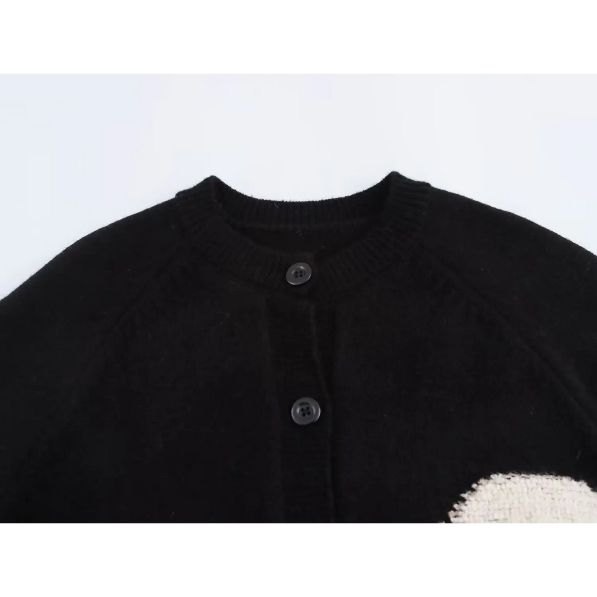 Close-up of crew neckline and button placket