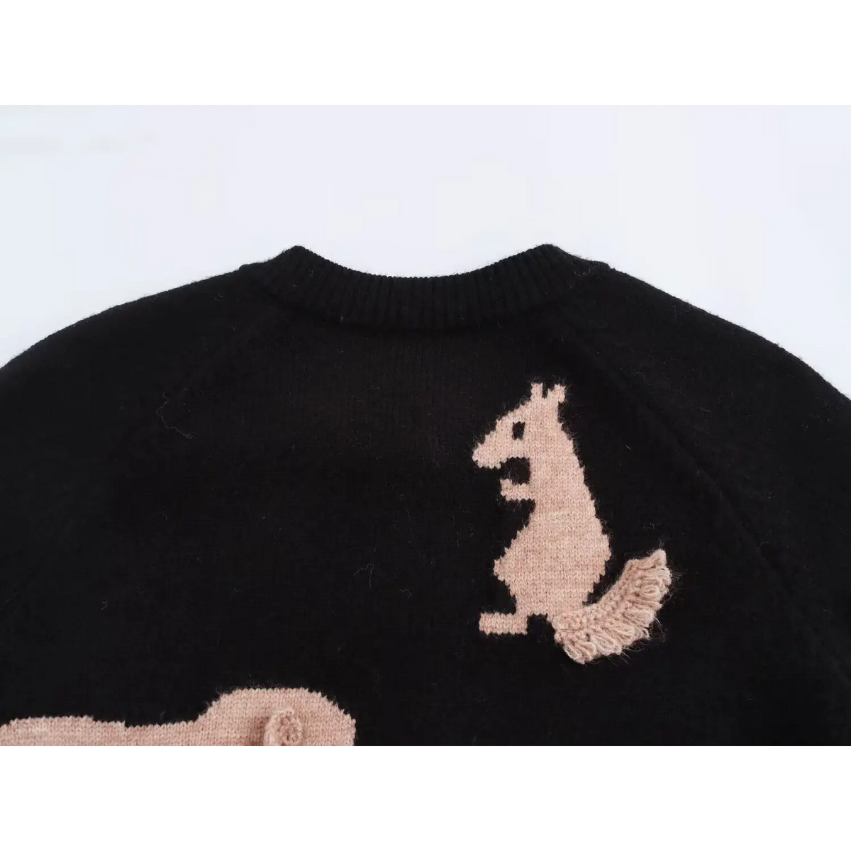 Close-up of squirrel intarsia and back neckline