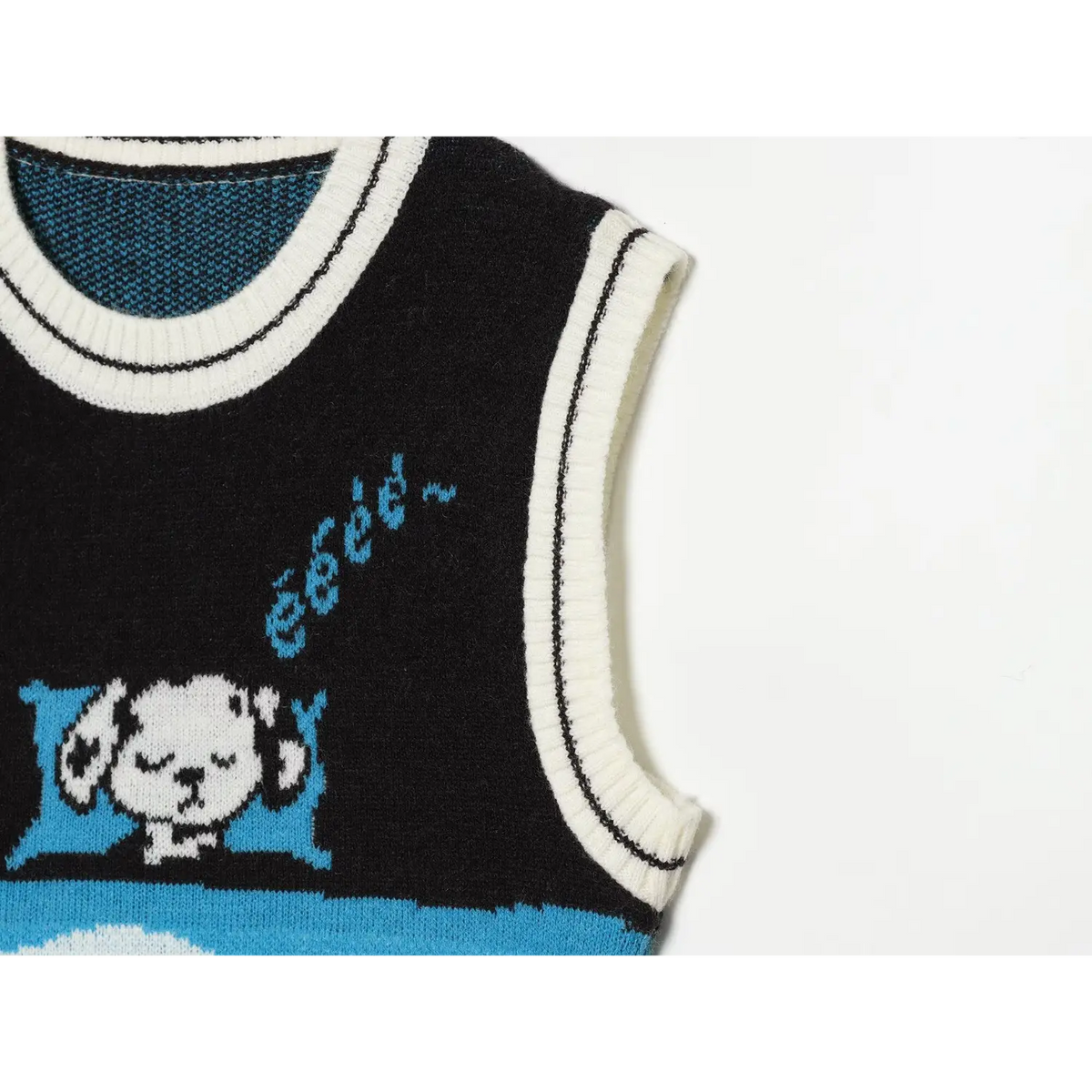 Close-up of armhole ribbed trim and cartoon dog intarsia