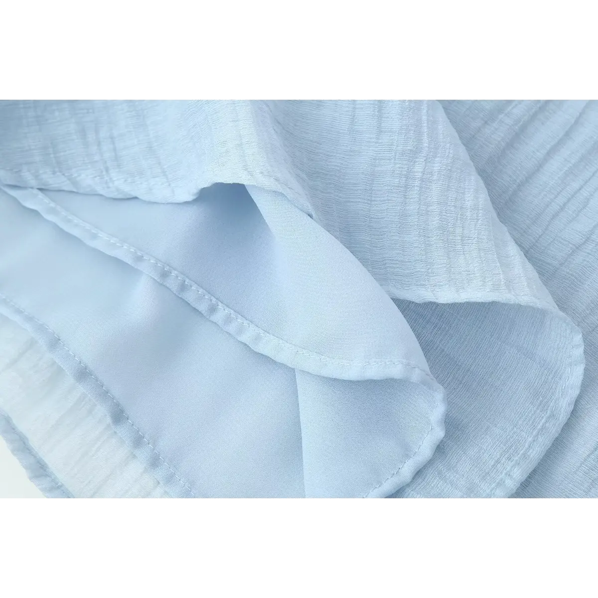 Clear close-up showing lightweight wrinkled fabric texture of summer cami top.