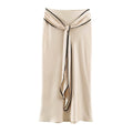 Model wearing champagne twist front satin slip midi skirt, front view
