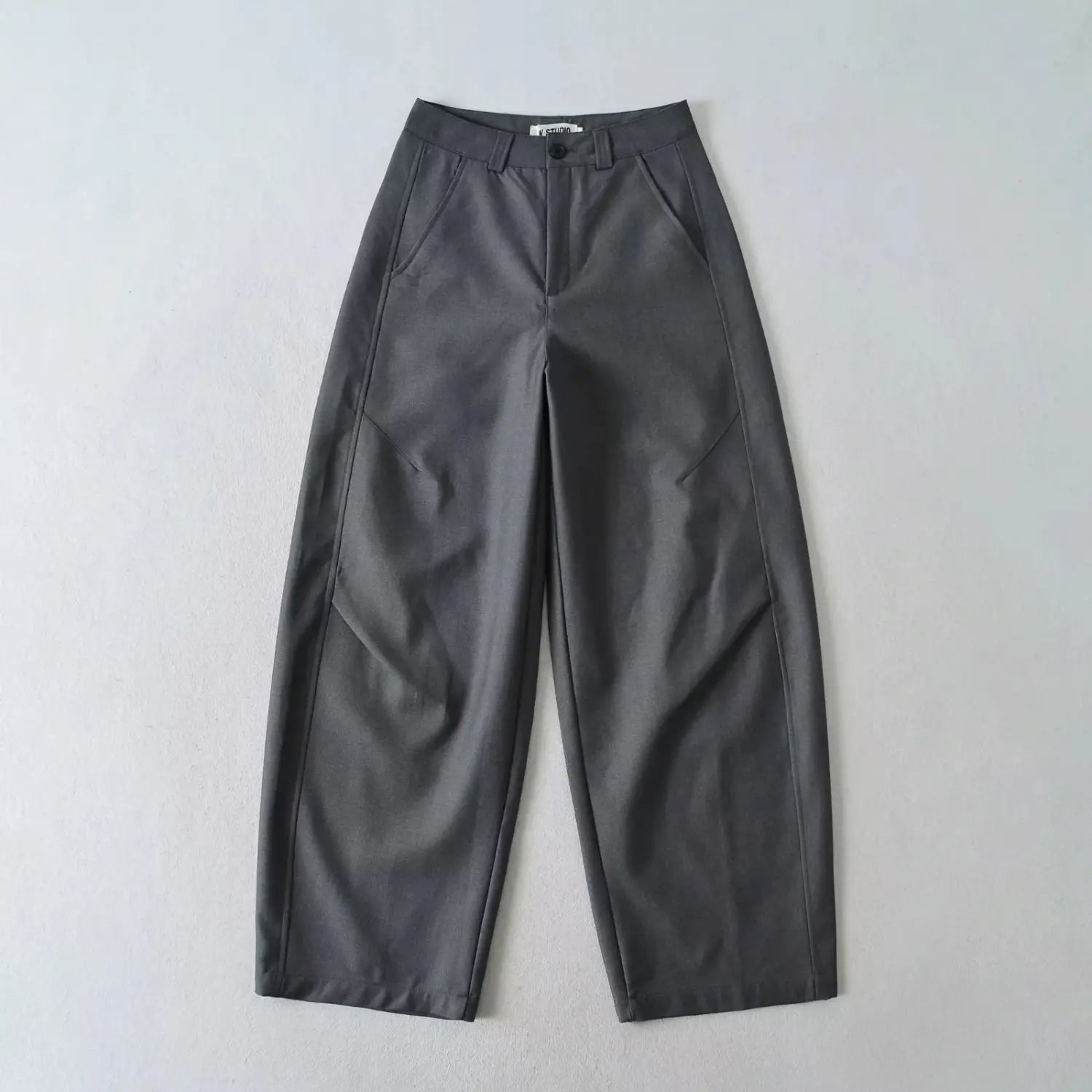 Single charcoal gray relaxed wide leg suit trousers front view flat lay on neutral white background