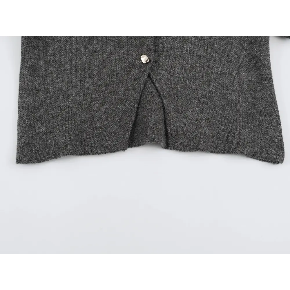 Close-up of center front hem split and metal button