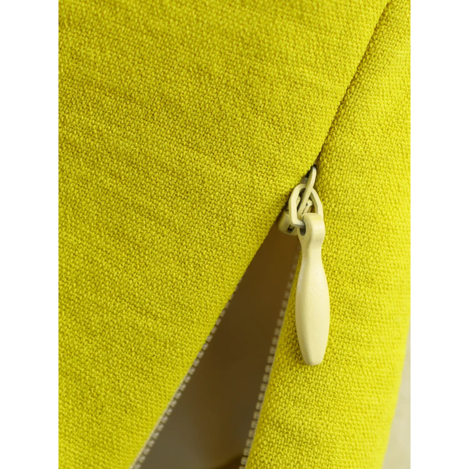 Close-up of side invisible zipper pull on chartreuse one-shoulder cropped vest
