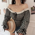 Black white check lace crop top side shot with straw hat held by model, clear display cuff ribbon tie flare sleeve neck lace ruffle waist smocked gathers distinct gingham fabric texture outfit shot