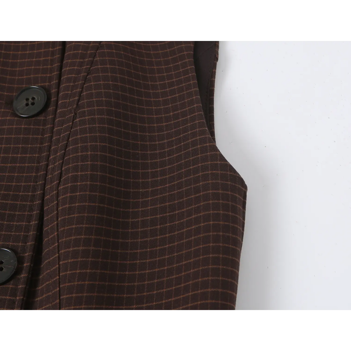 Close-up of armhole and check fabric