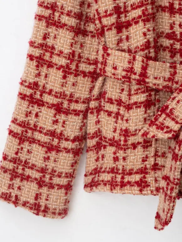 Close-up of self-tie belt and cuff tweed texture