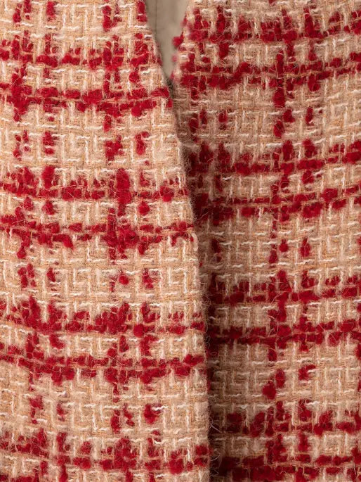 Macro close-up of beige and red check tweed texture