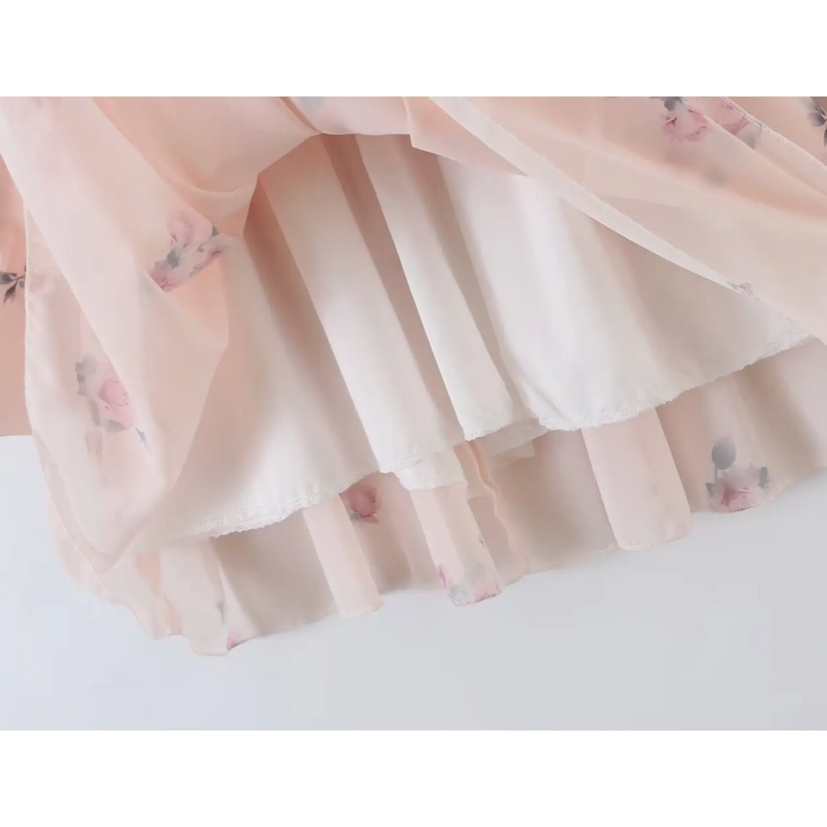 Inside view of dress, full solid color lining under sheer floral chiffon, neat stitched hem