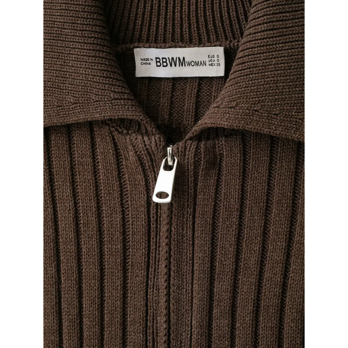 Close-up of inner brand label and metal zipper pull