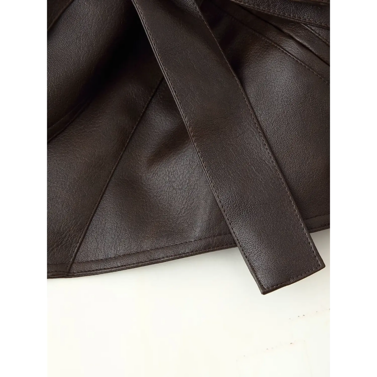 Close-up of belt tip and hem stitching