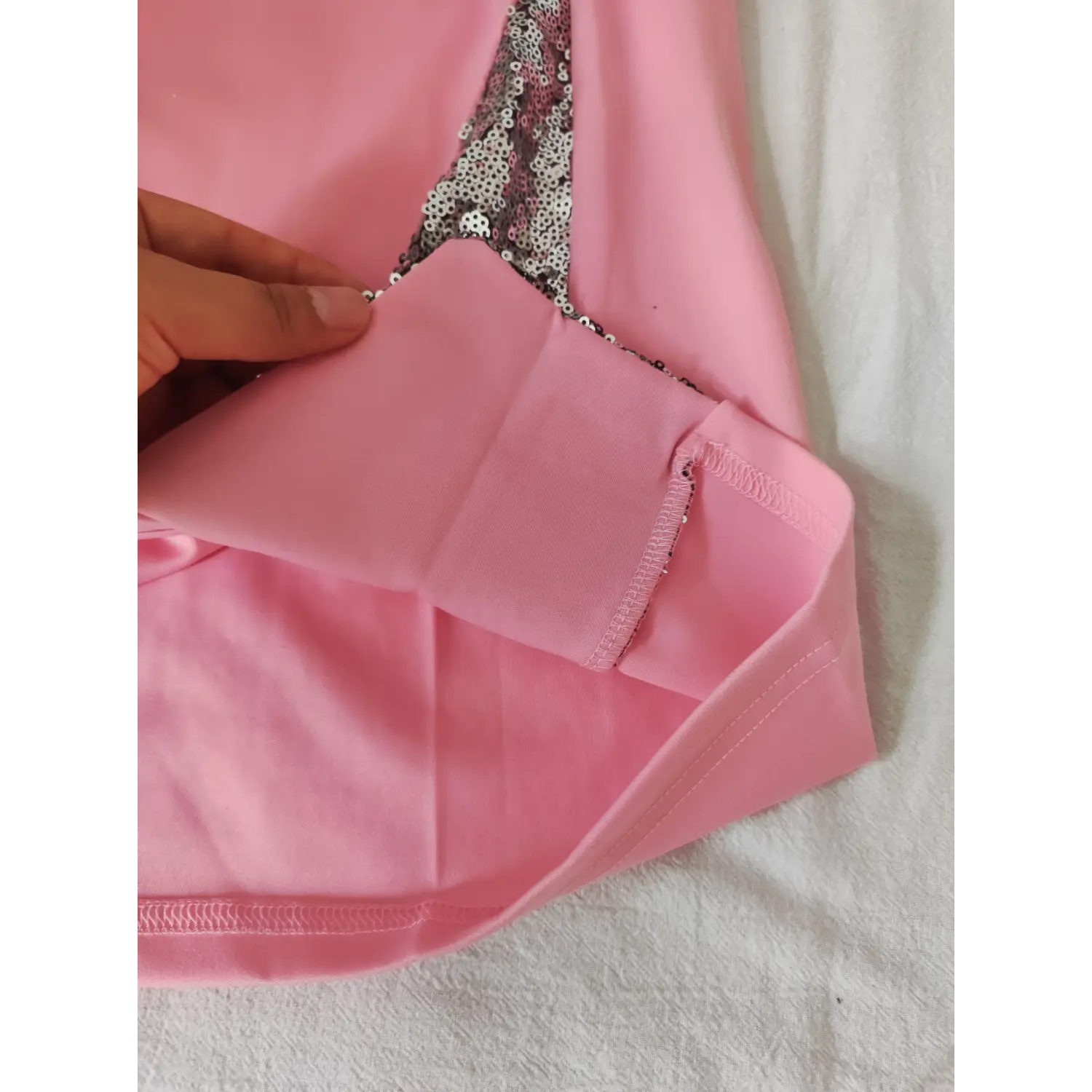  Close view inner lining and neat hem stitching detail of pink sequin spliced spaghetti strap dress