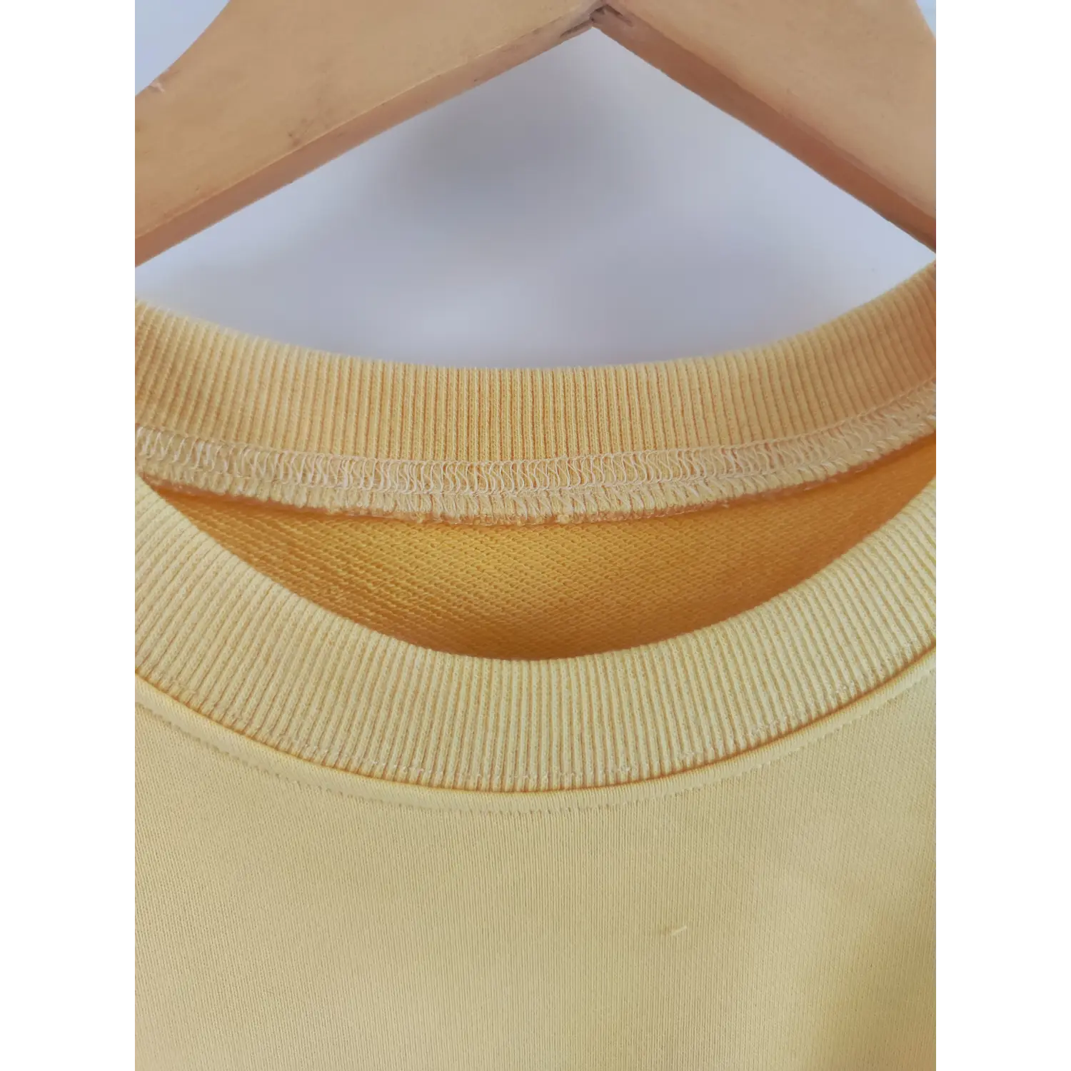 Close-up ribbed crew neck and seam detail yellow lightweight sweatshirt